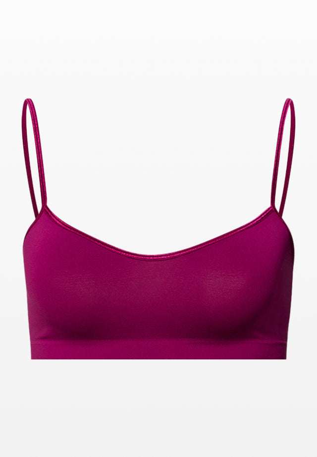 Pink bralette with thin straps on a white background