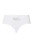 White underwear with a embroidered design on a white background
