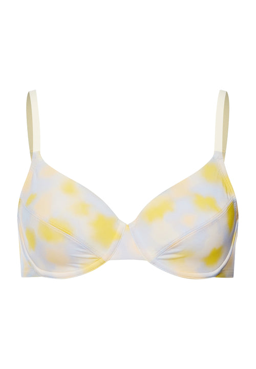 Yellow and white patterned bra on a white background