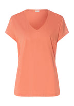 Coral-colored t-shirt on a white background