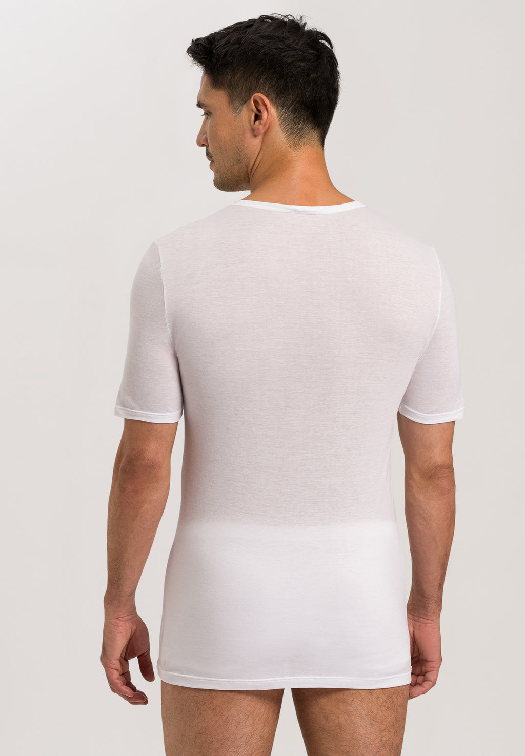 Man wearing a white t-shirt and underwear set on a plain background