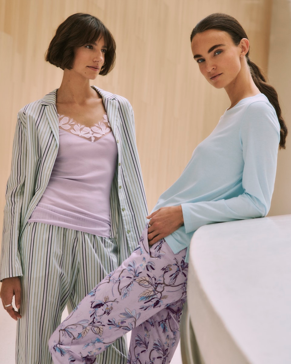 Two women wearing pajama sets in a casual setting.