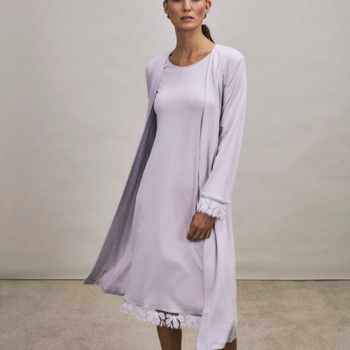 Woman wearing a Kalea light purple nightgown with a matching robe against a plain background