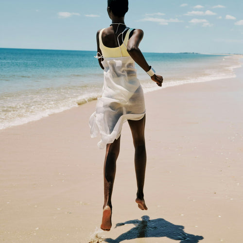 Person walking on a beach with ocean view