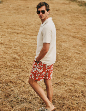 Man looking over his shoulder walking in a field 